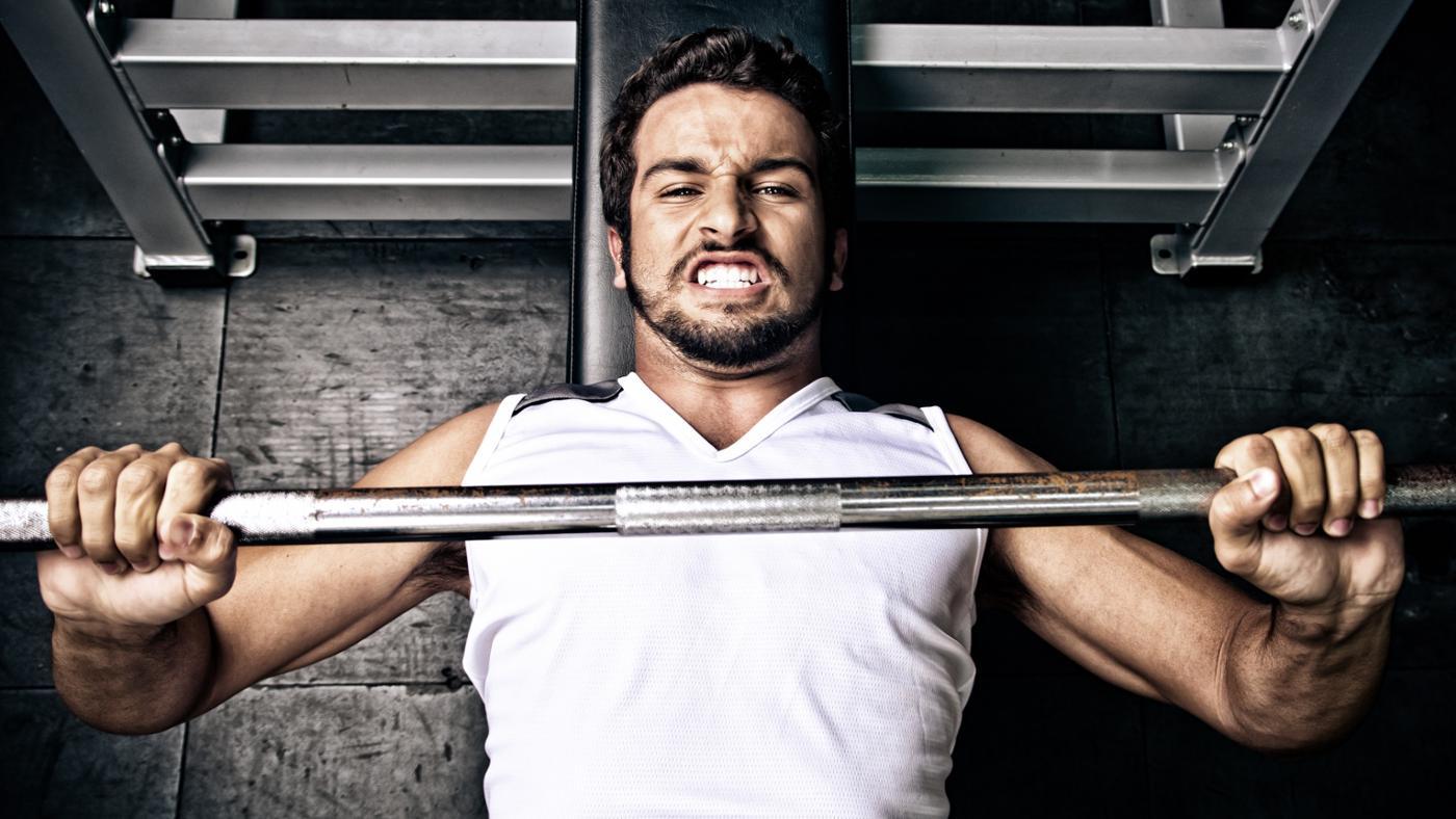 Image of a man using a bench press