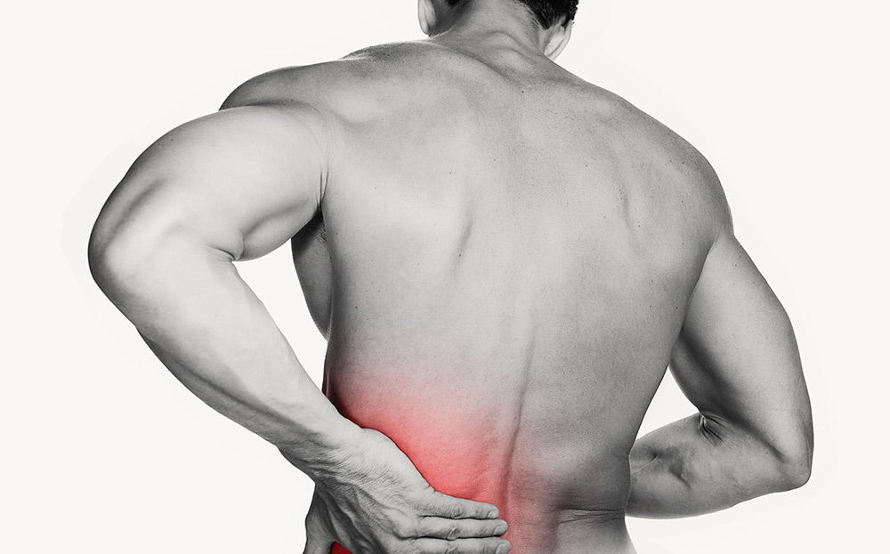 Image of a man grabbing his back due to muscle soreness and inflammation
