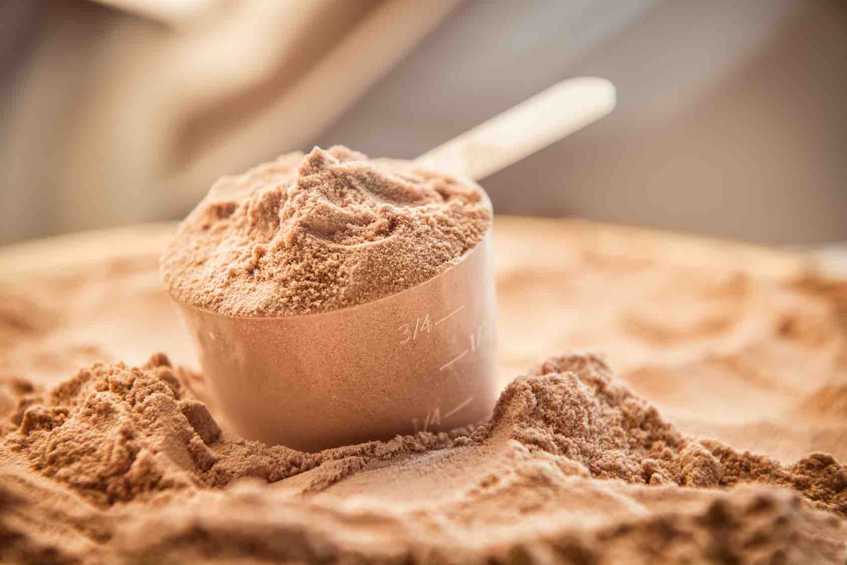 Image of a scoop of chocolate protein powder