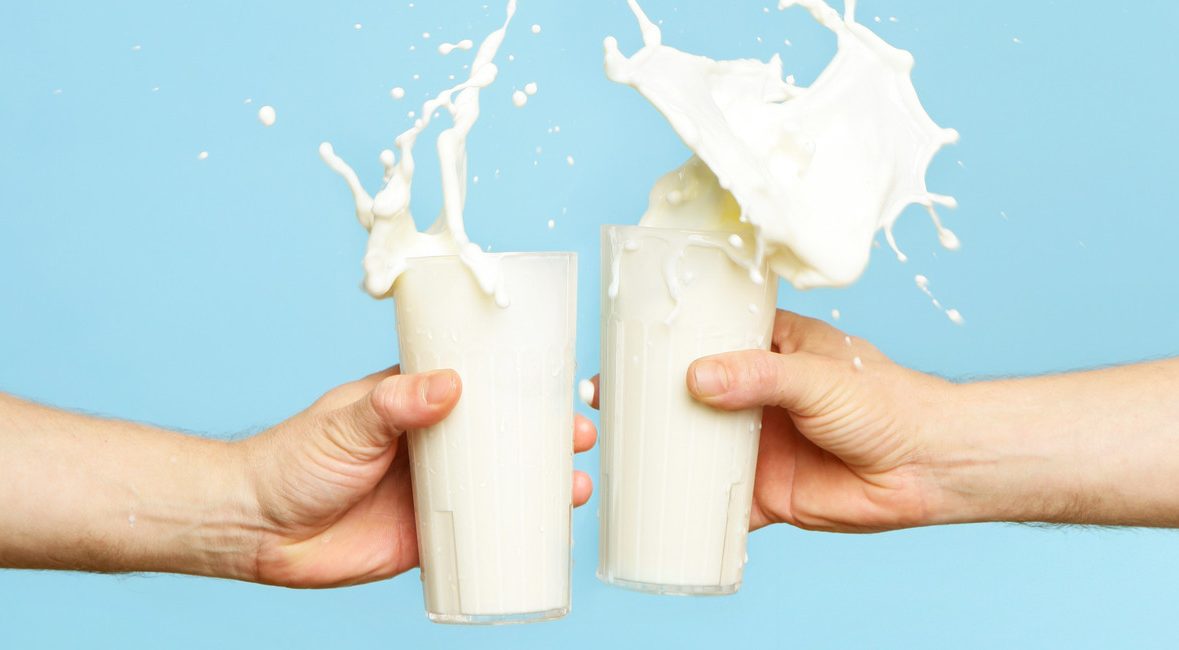 Image showing two people toasting milk glasses