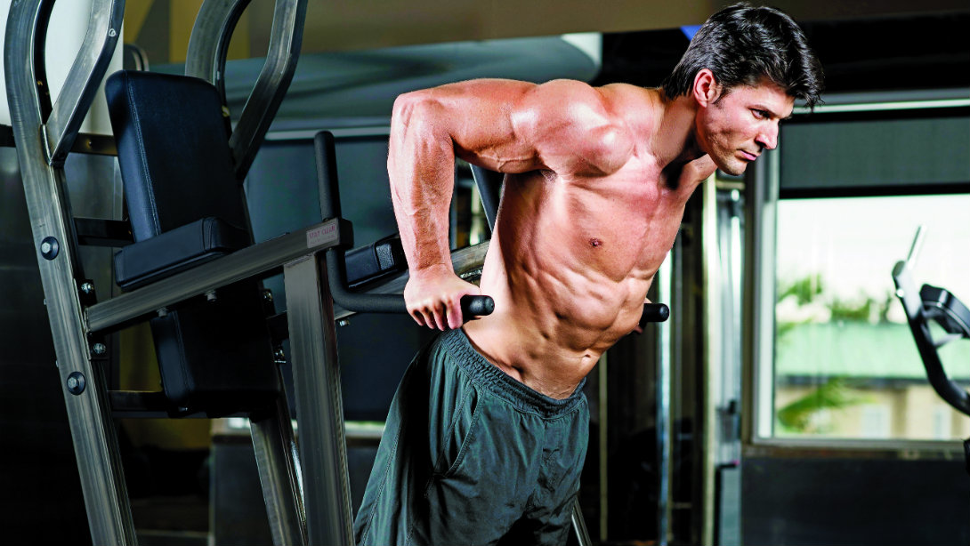 Image of a man doing chest dips on a dip station