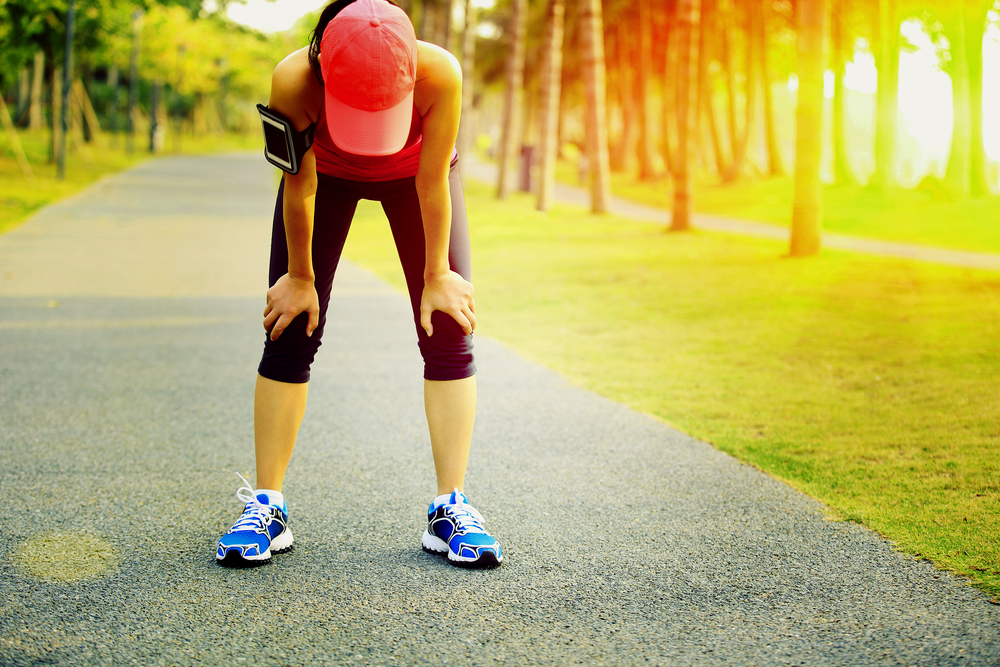 Image showing a woman bent over tired after a tough workout