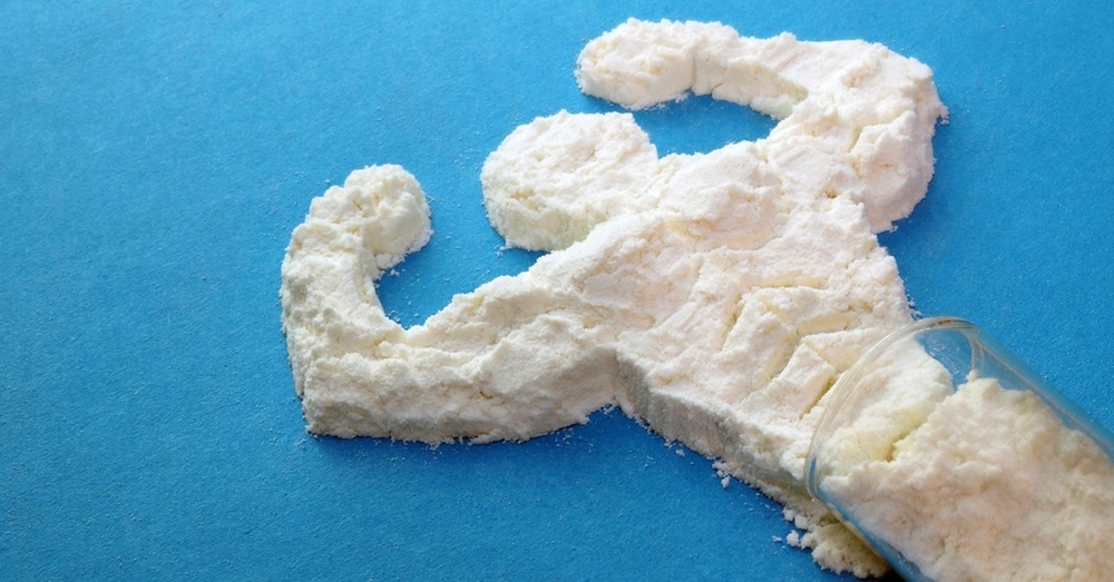 Image of creatine powder shaped like a man flexing muscles