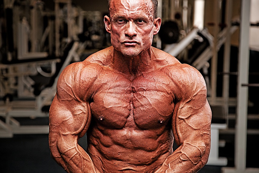 Image of a man flexing his muscles showing vascularity