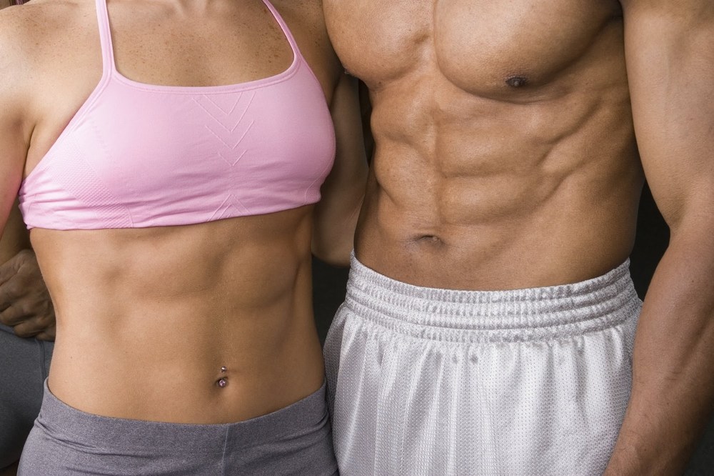 Image of a man and woman with six pack abs