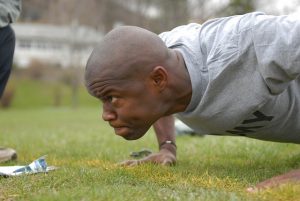 a soldier doing pushups with hands close together